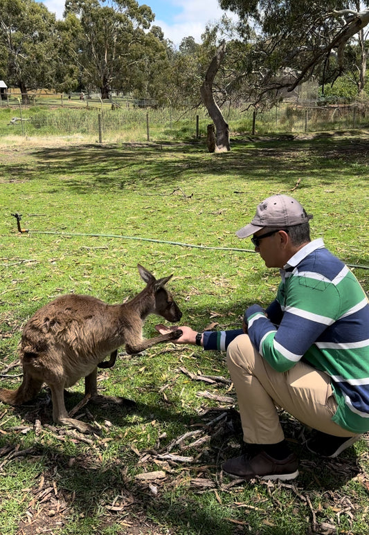My husband sharing a moment with a cute Wallaby.