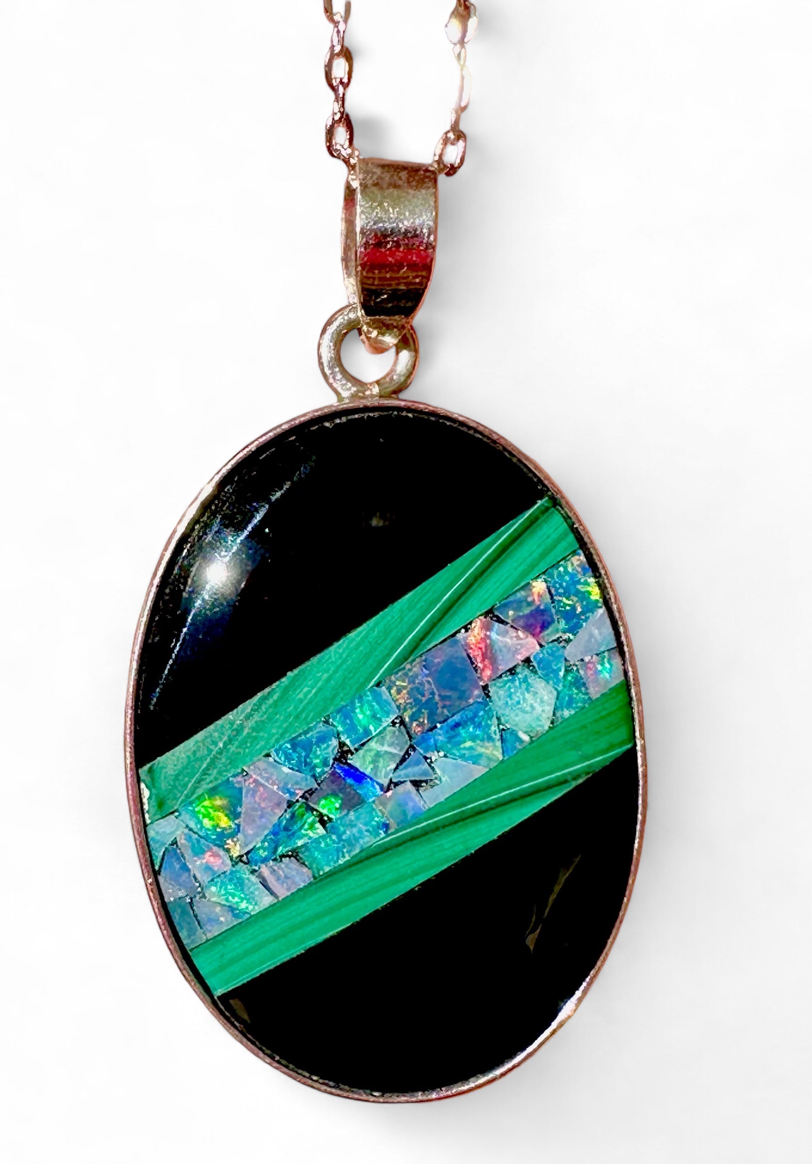 Black resin piece which has a layered top featuring an angled centre comprising of two Malachite strips on each side with an Inlayed Mosaic of solid Opal chips across the centre.