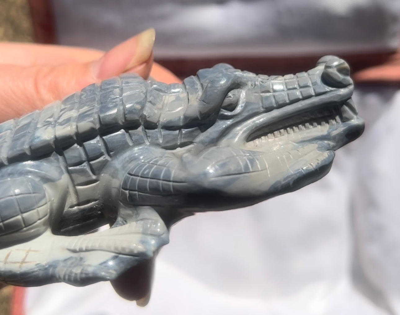 Detailed opal carving of a crocodile.