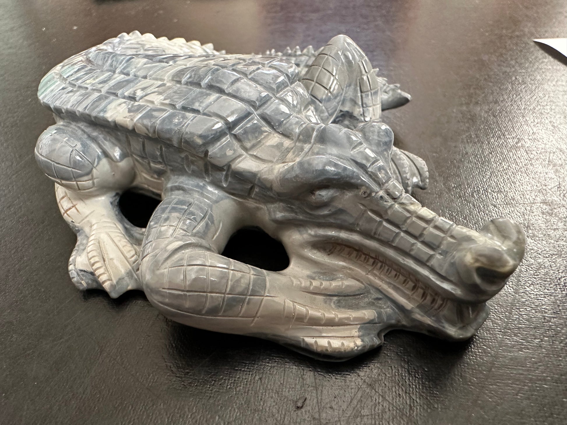 Detailed opal carving of a crocodile.