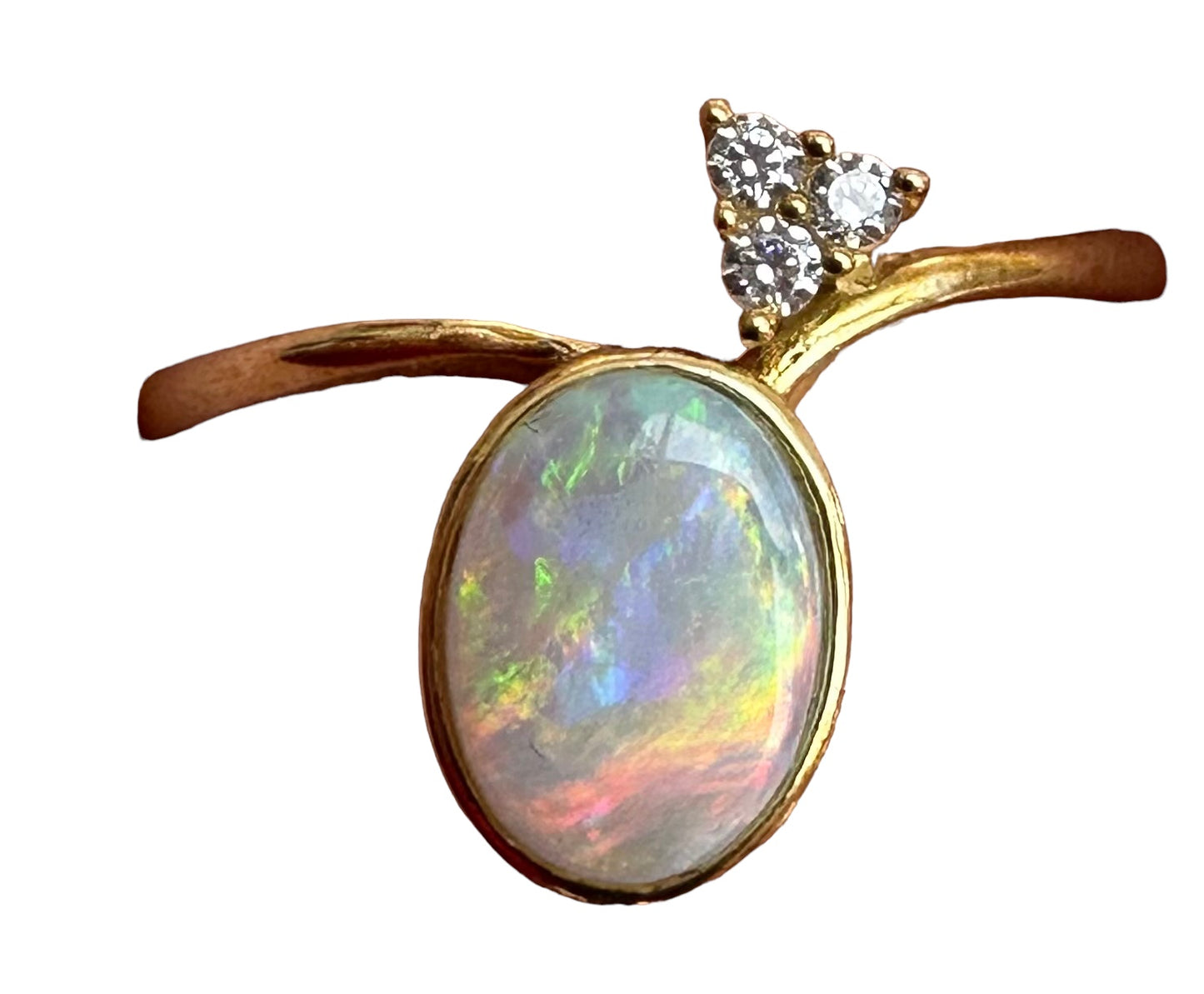  Unique Australian Opal Ring.  Oval shaped Natural Solid Crystal Opal.  All the colours of the rainbow.  Cubic Zirconia detail.  Solid 9k gold.  Size:  N 1/2   to    7 .  Opal measures : 8 x 6 mm  Cubic Zirconias measures : 1mm rounds  Weight : 8 ct  or  1.6 grams  All measurements are approximate.  (3581)